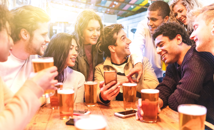 Diverse group of students drinking beer at a local bar