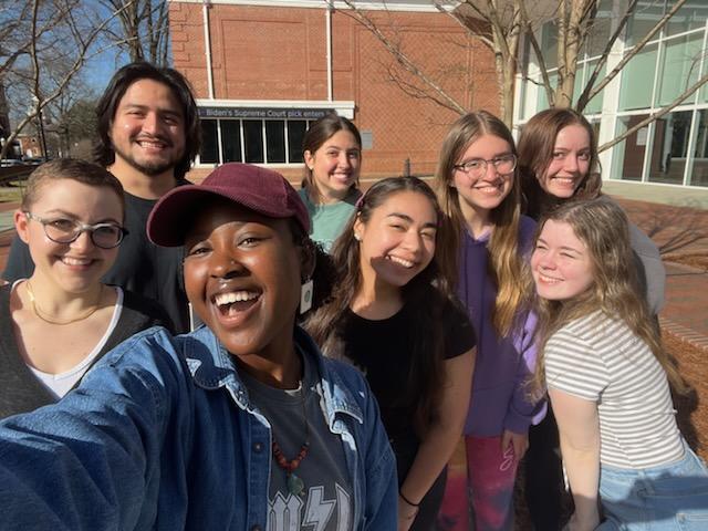 Diverse group of students posing for selfie outside