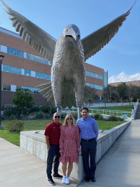 Student and parents in front of eagle statue at The University of Alabama