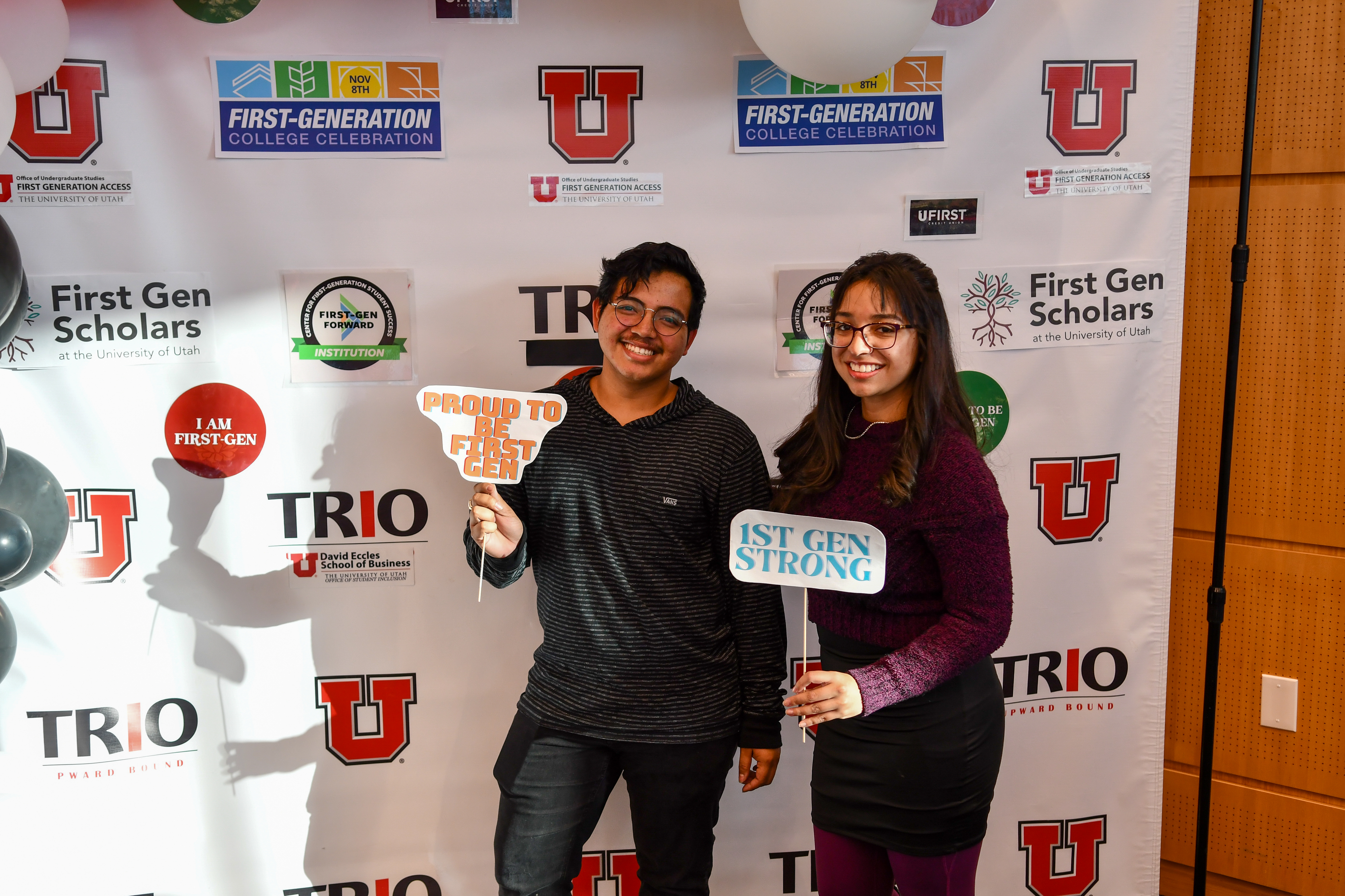 Students posing with step and repeat wall at University of Utah
