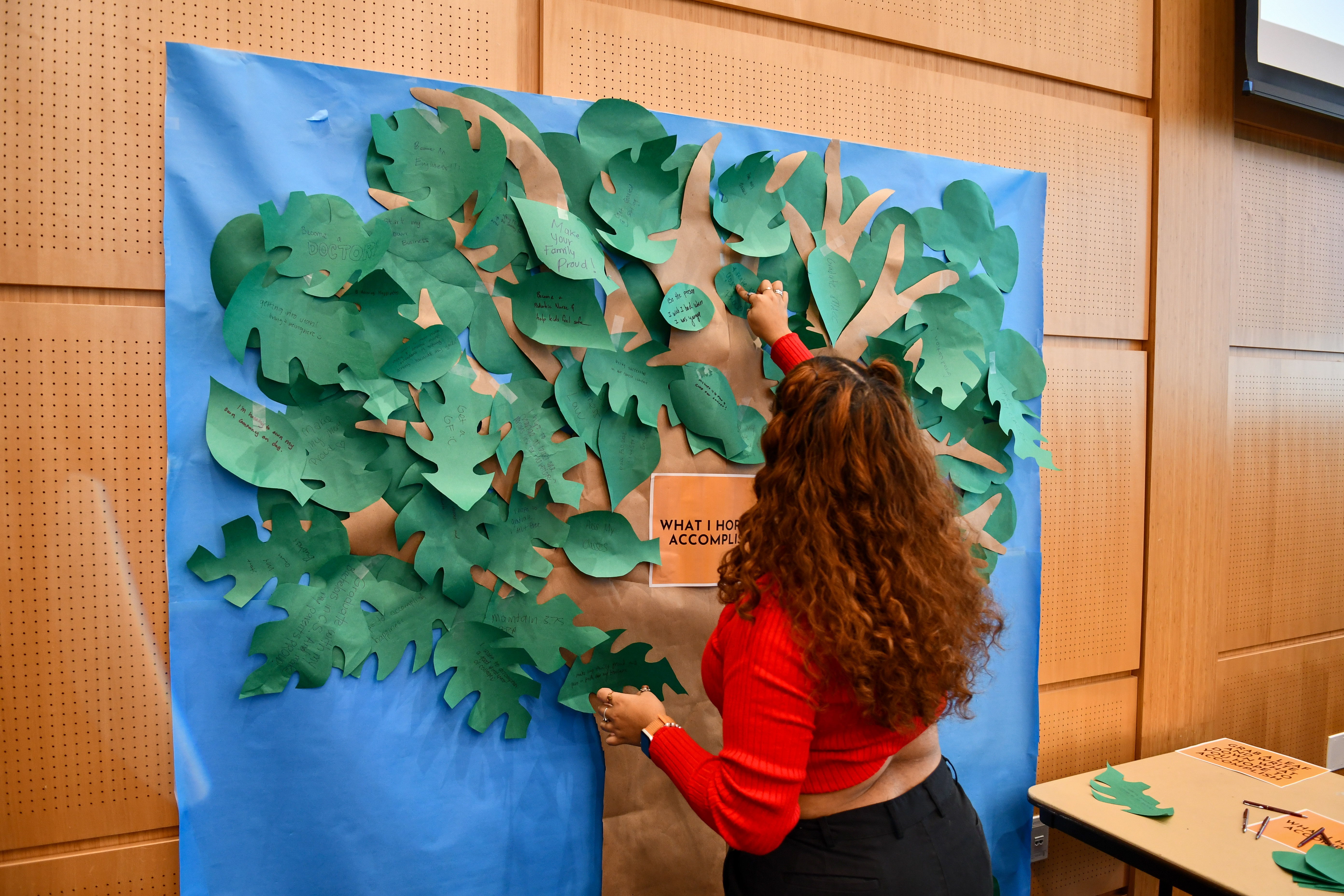 Student working on tree wall art project