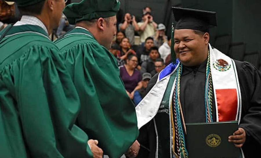 Student receiving diploma at Adams State University