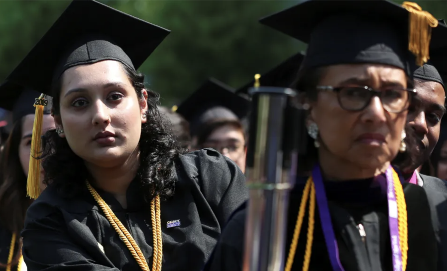 Diverse female graduates looking forward at commencement