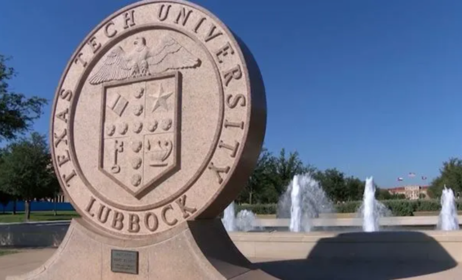 Concrete Texas Tech University seal outside on sunny day in front of fountains