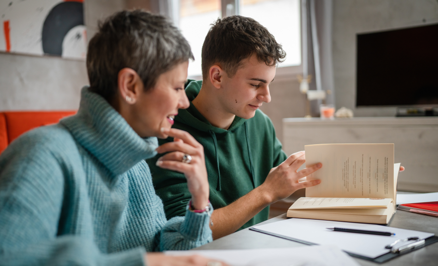 Male student studying with parent