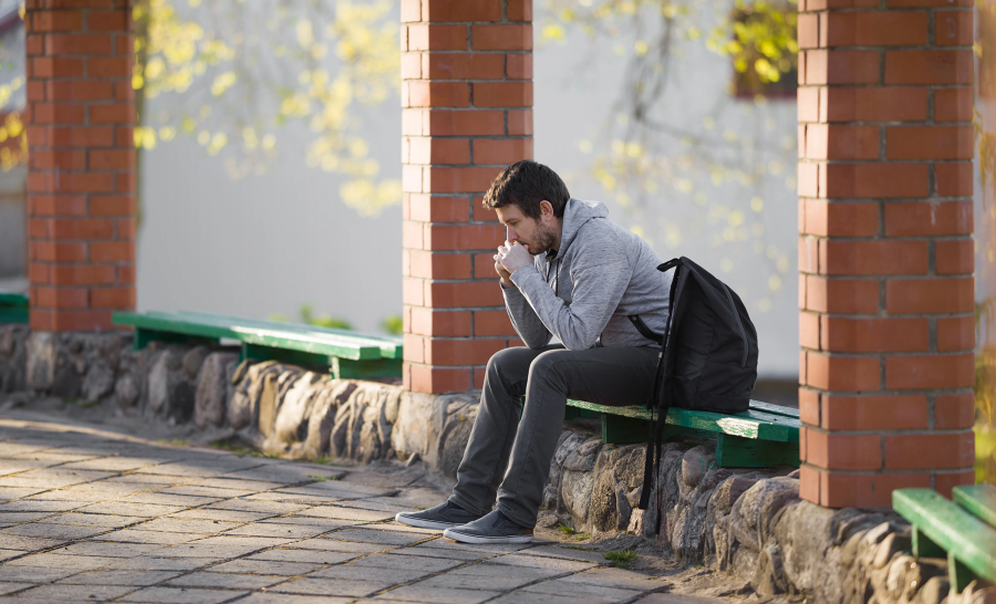 Male Student sitting alone outside