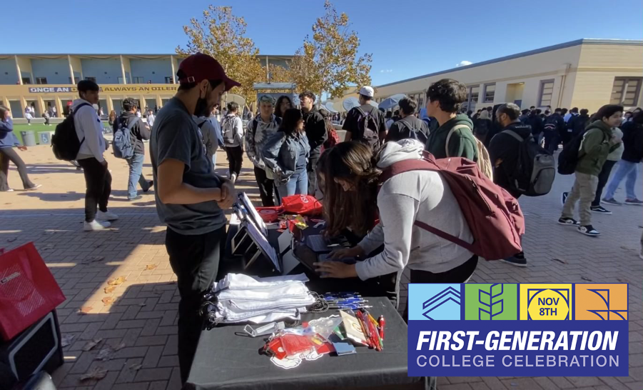 Students tabling outside with first-gen swag