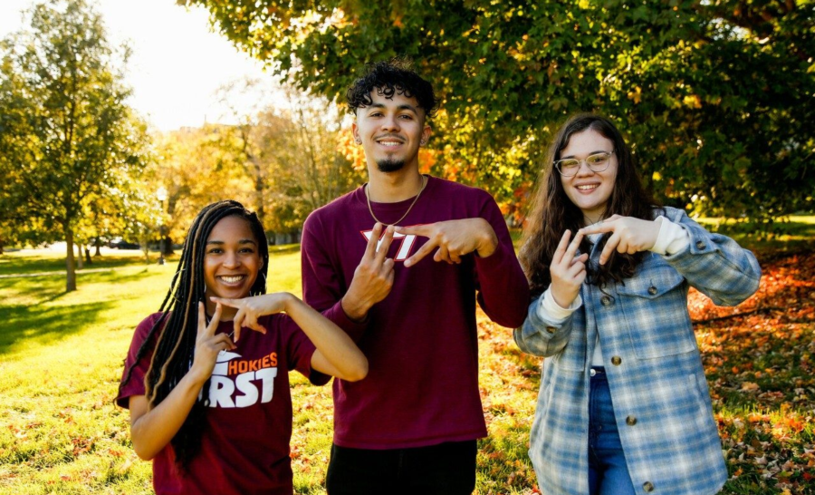 Virginia Tech Students Making VT hand sign outside