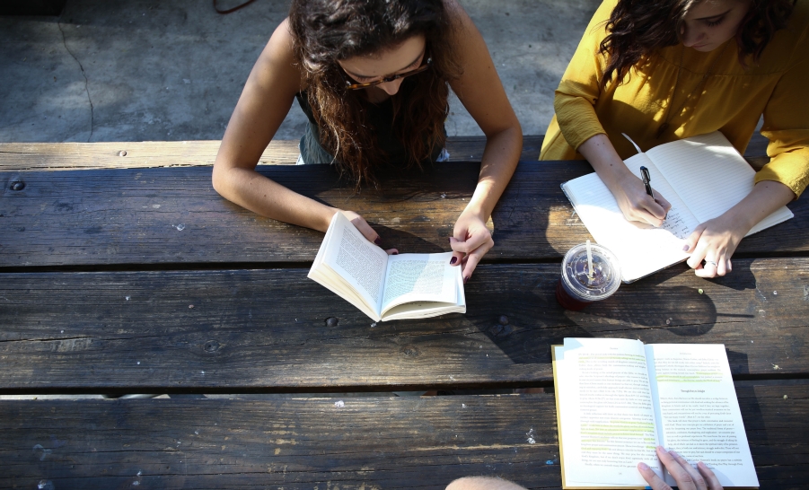students around table with books