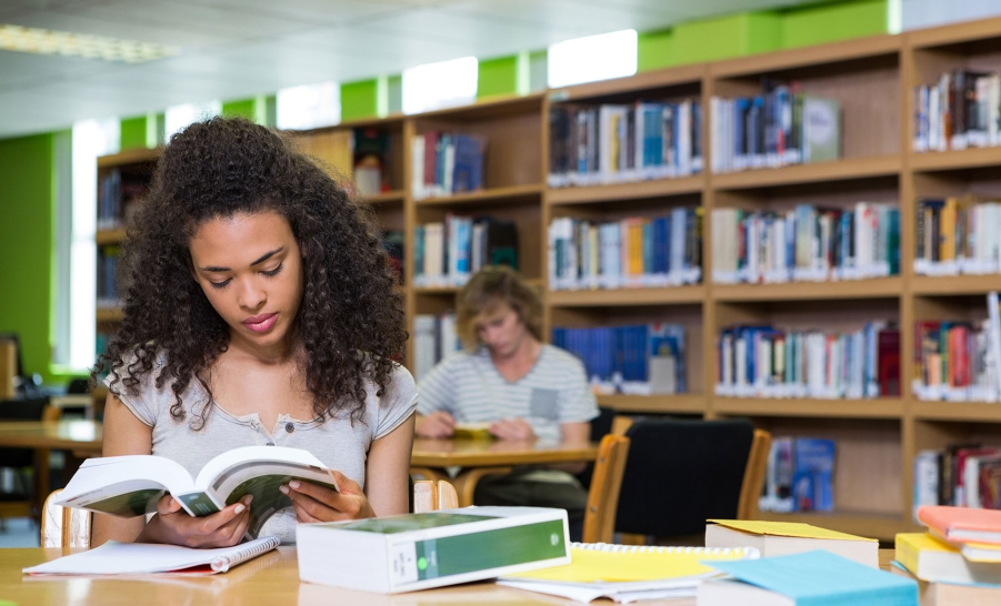 black female reading in library