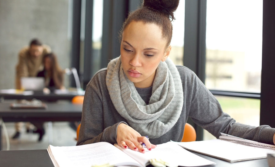 female student grey scarf studying