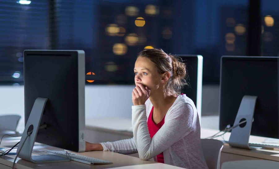 female student on computer at night